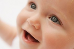 a smiling happy baby that benefited from baby proofing consultations