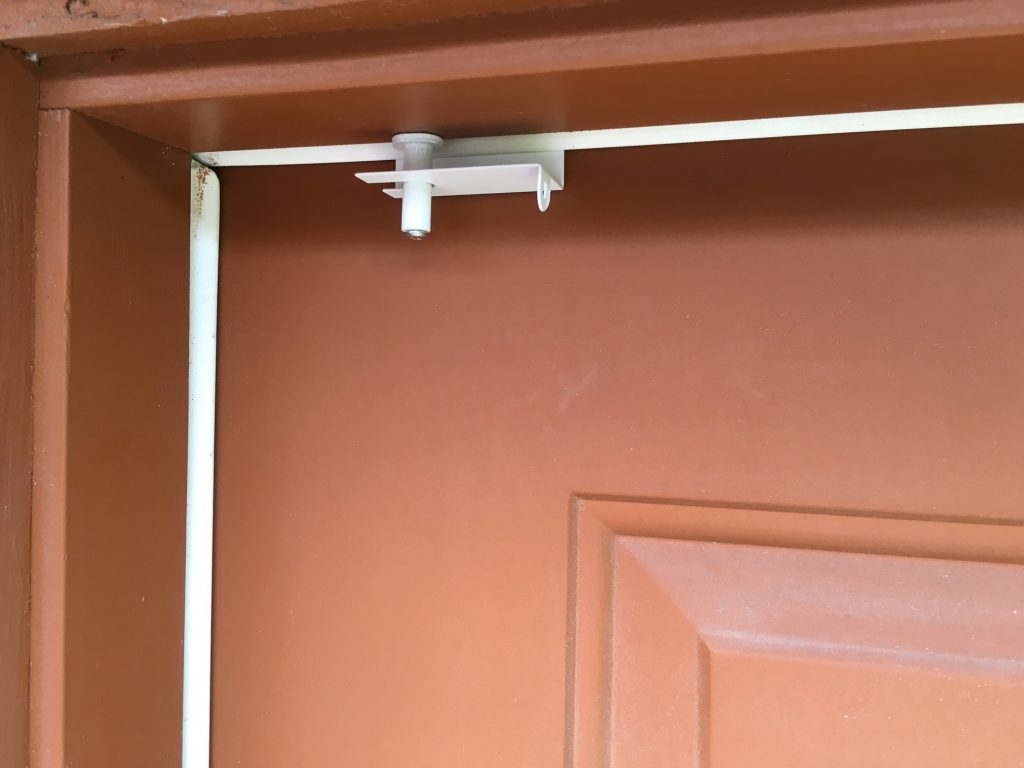 GlideLok installed on an exterior door with weather stripping.